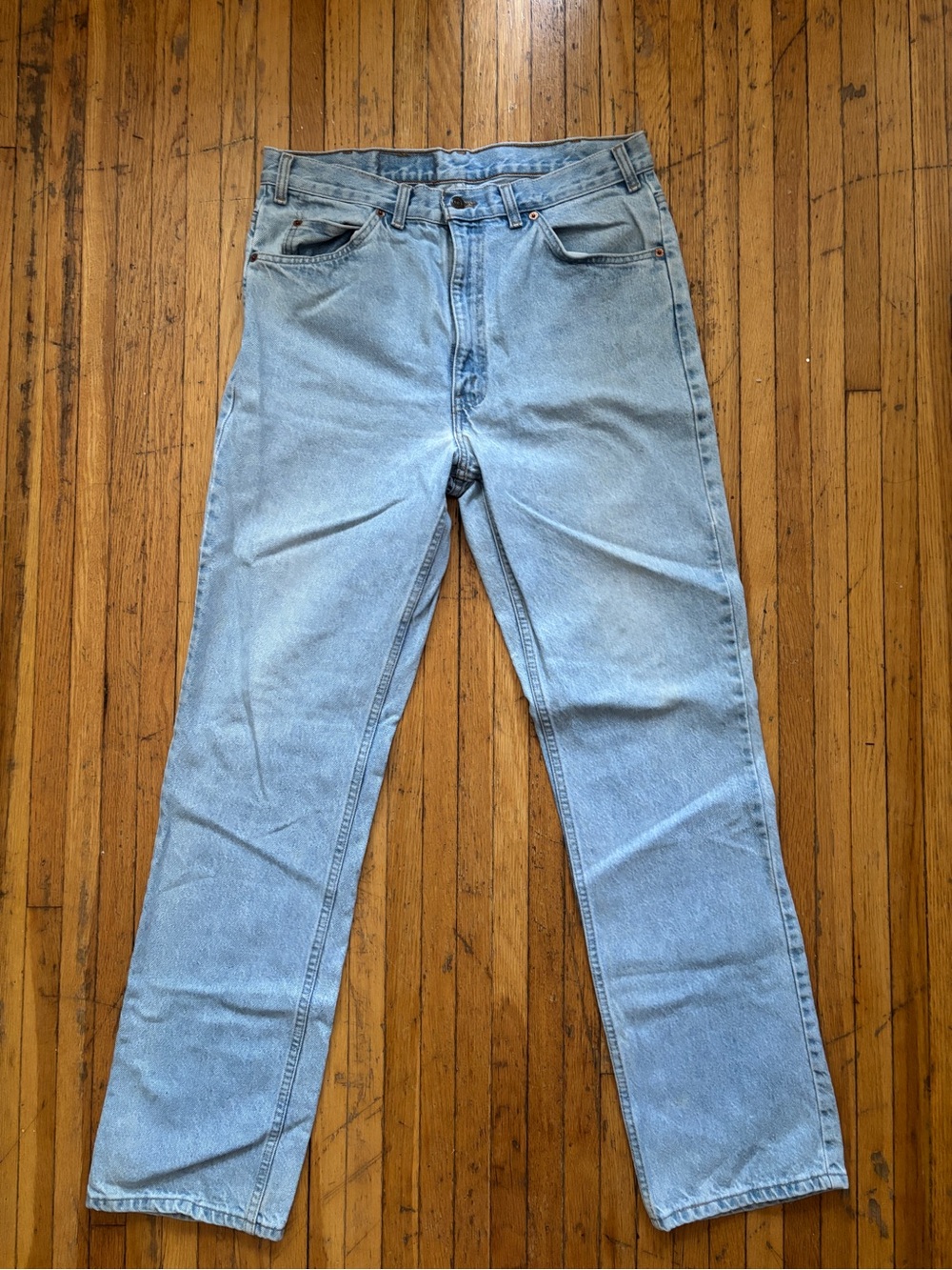Vintage orange tab Levi’s light wash slim straight leg denim jeans